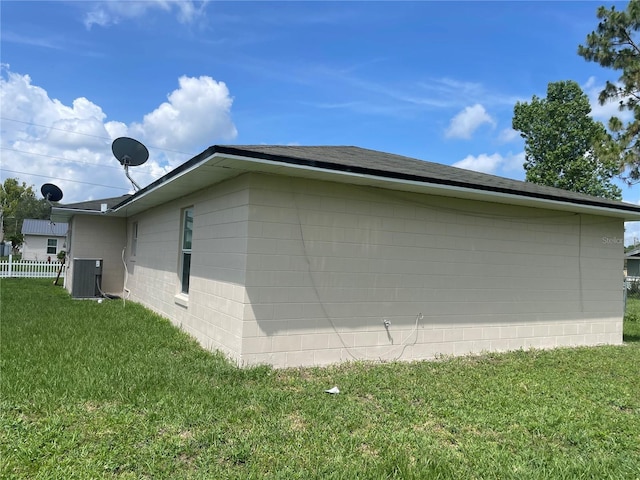 909 San Paulo Way, Kissimmee, FL 34758 - view of home's exterior featuring concrete block siding, central AC, and roof with shingles