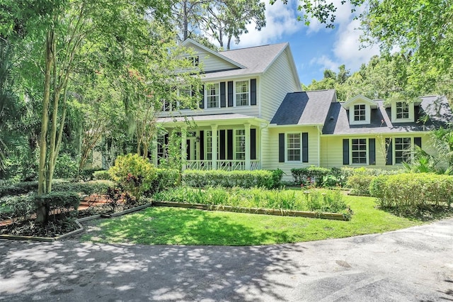 914 Elysium Blvd, Mount Dora, FL 32757 - view of front facade with a porch, a front lawn, and roof with shingles