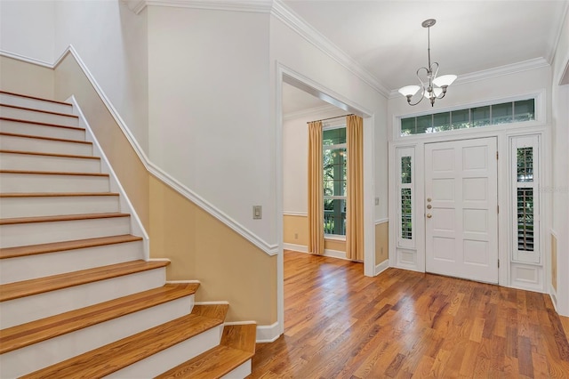 914 Elysium Blvd, Mount Dora, FL 32757 - foyer featuring a chandelier, stairs, ornamental molding, and wood finished floors