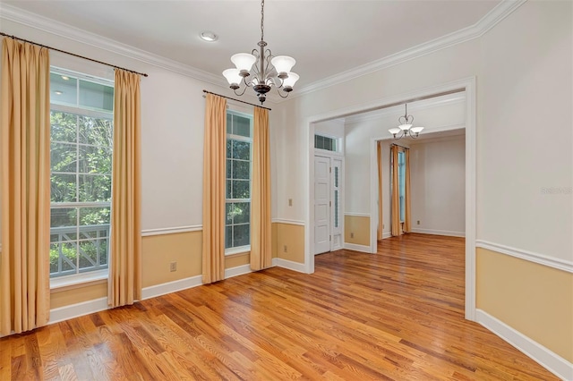 914 Elysium Blvd, Mount Dora, FL 32757 - empty room with a chandelier, light wood-style flooring, and crown molding