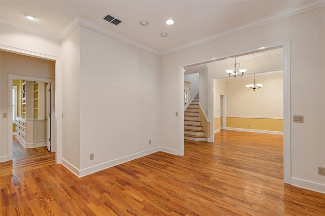 914 Elysium Blvd, Mount Dora, FL 32757 - spare room featuring light wood finished floors, a chandelier, stairs, crown molding, and recessed lighting