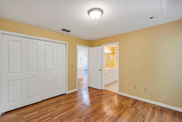 914 Elysium Blvd, Mount Dora, FL 32757 - unfurnished bedroom with a closet, light wood-type flooring, and ensuite bathroom