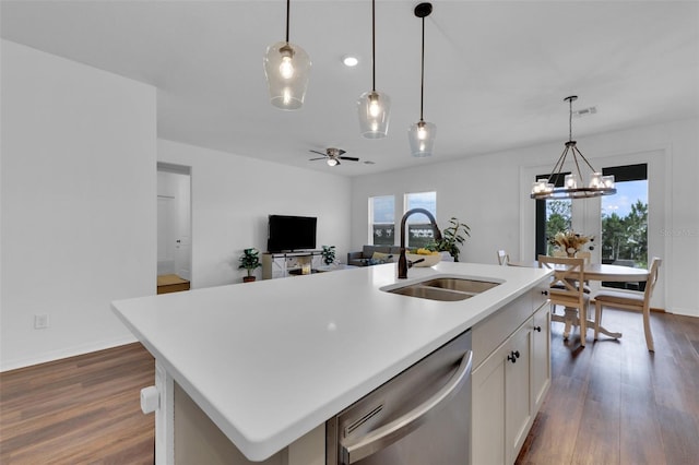 2210 Derwent Dr, Davenport, FL 33896 - kitchen with a sink, dishwasher, dark wood-style flooring, and a center island with sink