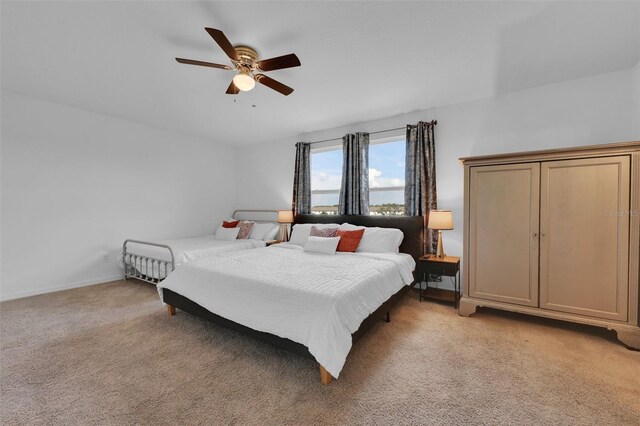 2210 Derwent Dr, Davenport, FL 33896 - bedroom featuring light colored carpet, a ceiling fan, and baseboards