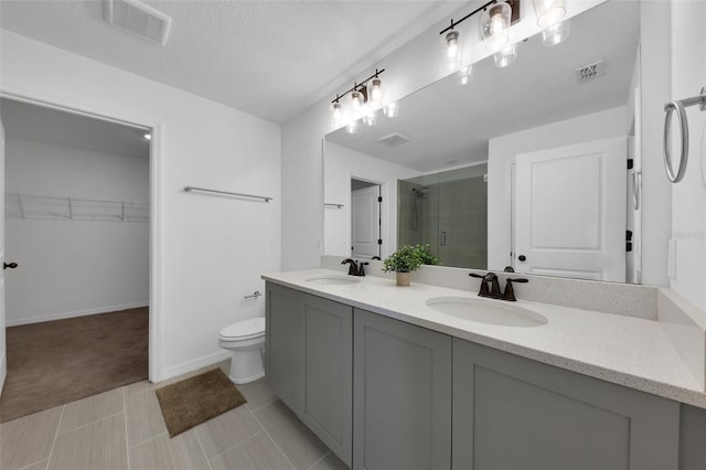 2210 Derwent Dr, Davenport, FL 33896 - full bathroom featuring a shower stall, double vanity, a walk in closet, toilet, and baseboards