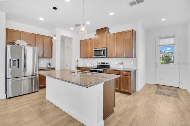 3280 Canna Lily Pl, Clermont, FL 34711 - kitchen with appliances with stainless steel finishes, a sink, light wood-style floors, dark stone countertops, and recessed lighting