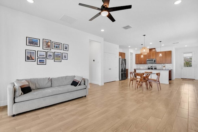 3280 Canna Lily Pl, Clermont, FL 34711 - living area with recessed lighting, a ceiling fan, baseboards, and light wood-style flooring