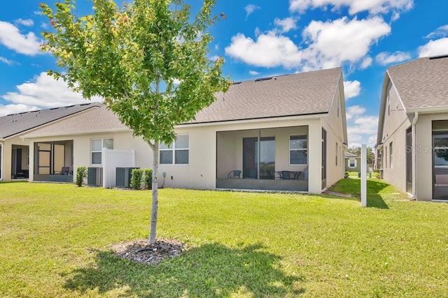 3280 Canna Lily Pl, Clermont, FL 34711 - back of property with stucco siding, a yard, central AC unit, and a sunroom