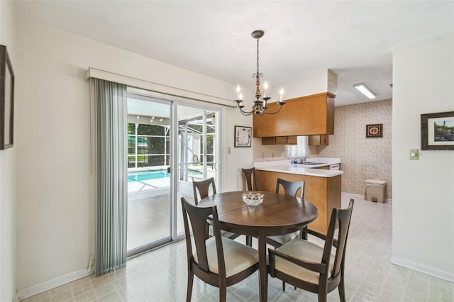 620 Marshall St, Altamonte Springs, FL 32701 - dining space with baseboards, a chandelier, light flooring, and wallpapered walls