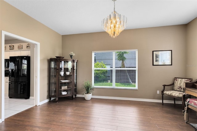 2214 Westbourne Dr, Oviedo, FL 32765 - living area featuring a chandelier, wood-type flooring, and baseboards