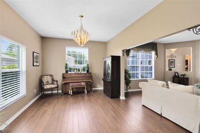 2214 Westbourne Dr, Oviedo, FL 32765 - living area featuring a chandelier, dark wood finished floors, and baseboards
