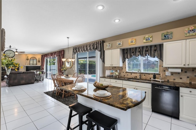 2214 Westbourne Dr, Oviedo, FL 32765 - kitchen featuring black dishwasher, a sink, light tile patterned flooring, open floor plan, and healthy amount of natural light