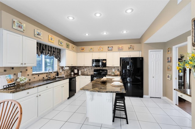 2214 Westbourne Dr, Oviedo, FL 32765 - kitchen with black appliances, a sink, tasteful backsplash, recessed lighting, and a breakfast bar