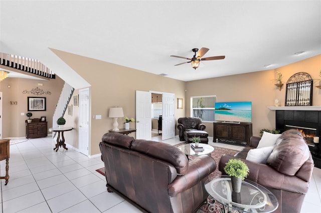 2214 Westbourne Dr, Oviedo, FL 32765 - living room with light tile patterned floors, ceiling fan, and a fireplace