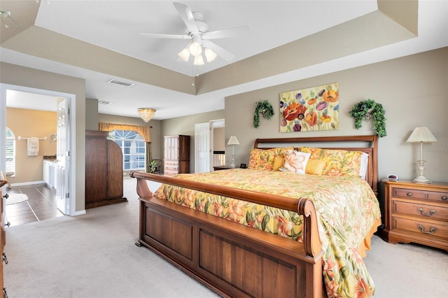 2214 Westbourne Dr, Oviedo, FL 32765 - bedroom with a tray ceiling, light carpet, multiple windows, and baseboards