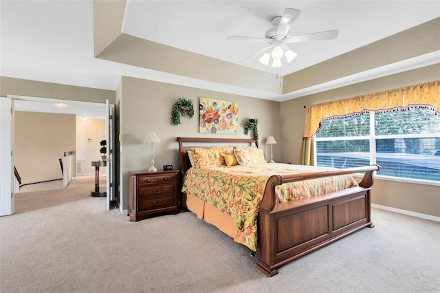 2214 Westbourne Dr, Oviedo, FL 32765 - bedroom featuring light carpet, a tray ceiling, baseboards, and a ceiling fan