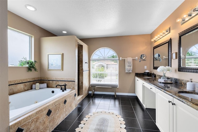 2214 Westbourne Dr, Oviedo, FL 32765 - full bath featuring a tub with jets, double vanity, tile patterned floors, baseboards, and recessed lighting