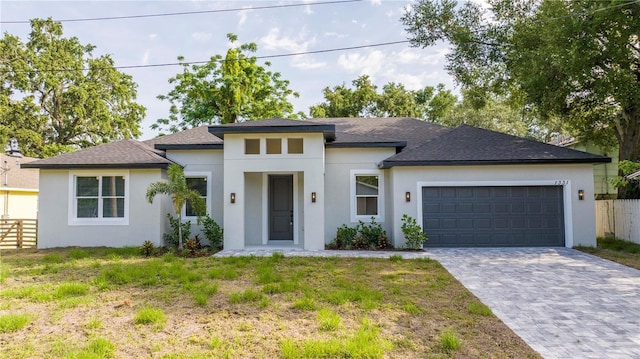 1331 19th St, Orlando, FL 32805 - prairie-style home featuring stucco siding, an attached garage, decorative driveway, and a shingled roof