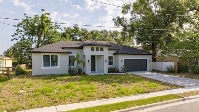 1331 19th St, Orlando, FL 32805 - view of front of home with stucco siding, an attached garage, decorative driveway, and a shingled roof