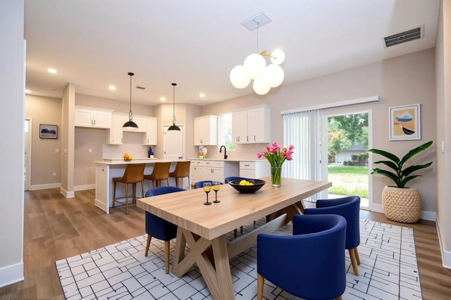 1331 19th St, Orlando, FL 32805 - dining room featuring light wood finished floors, baseboards, healthy amount of natural light, a chandelier, and recessed lighting