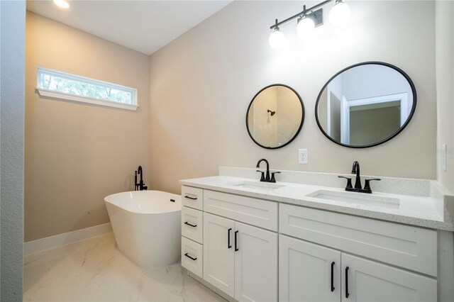 1331 19th St, Orlando, FL 32805 - bathroom featuring double vanity, a freestanding bath, and marble look tile flooring