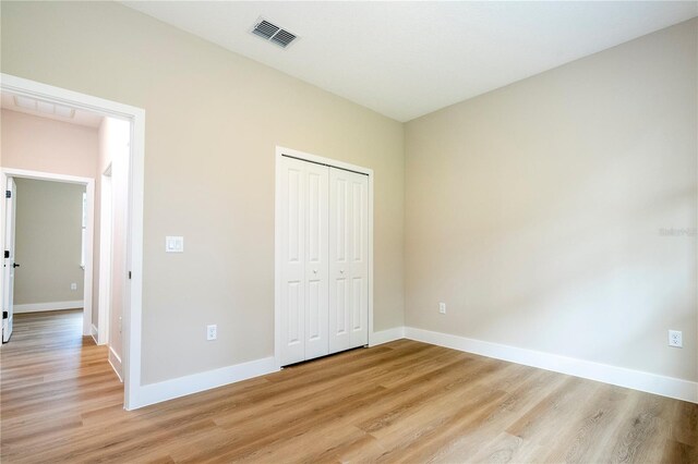 1331 19th St, Orlando, FL 32805 - unfurnished bedroom with light wood-type flooring, baseboards, and a closet