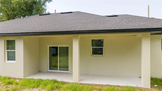 1331 19th St, Orlando, FL 32805 - back of house featuring roof with shingles, stucco siding, and a patio area