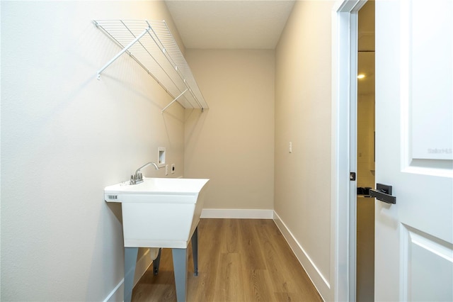 1331 19th St, Orlando, FL 32805 - washroom featuring washer hookup, wood finished floors, and baseboards