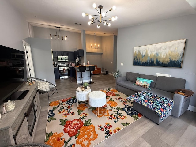 3391 S Kirkman Rd Unit 1236, Orlando, FL 32811 - living room featuring a chandelier, light wood-style flooring, and baseboards