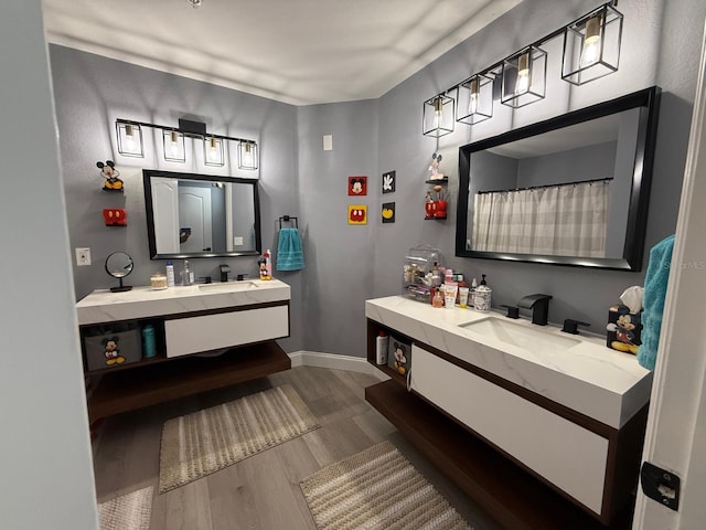 3391 S Kirkman Rd Unit 1236, Orlando, FL 32811 - bathroom with wood finished floors, vanity, and baseboards