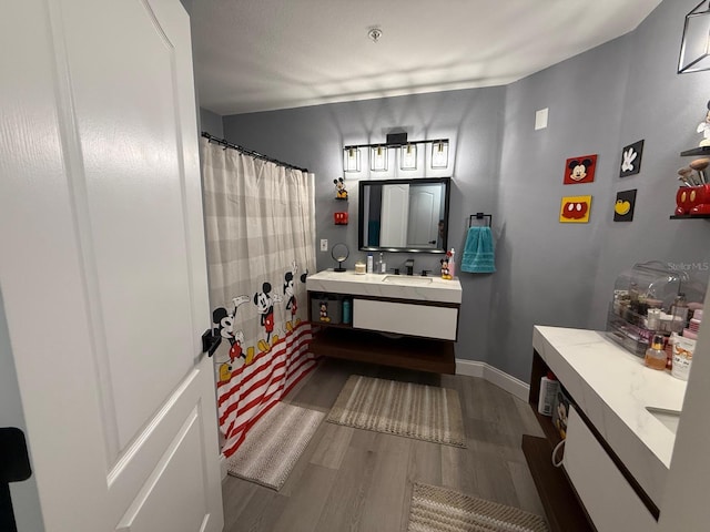 3391 S Kirkman Rd Unit 1236, Orlando, FL 32811 - bathroom featuring wood finished floors, vanity, baseboards, and a shower with curtain