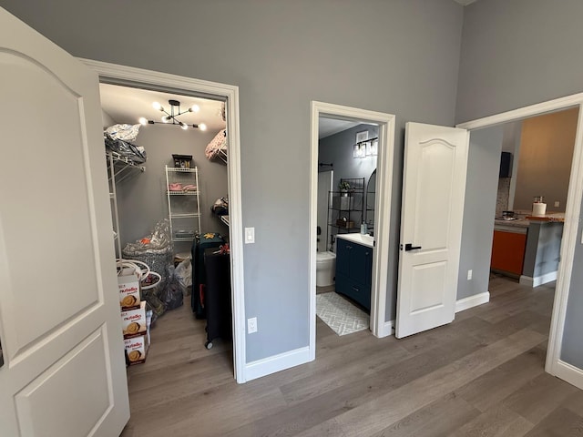 3391 S Kirkman Rd Unit 1236, Orlando, FL 32811 - bedroom with a walk in closet, wood finished floors, a closet, baseboards, and ensuite bath