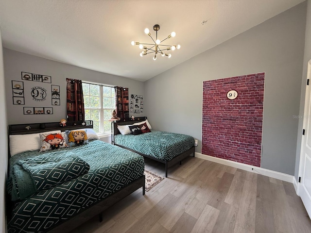 3391 S Kirkman Rd Unit 1236, Orlando, FL 32811 - bedroom with vaulted ceiling, a chandelier, baseboards, and wood finished floors