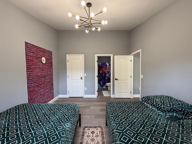 3391 S Kirkman Rd Unit 1236, Orlando, FL 32811 - bedroom featuring a chandelier, wood finished floors, baseboards, and a towering ceiling