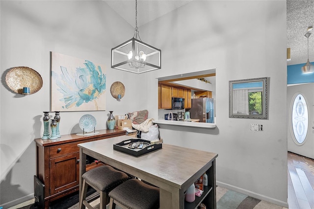 116 Candlewick Ct, Sanford, FL 32771 - dining area featuring a textured ceiling, baseboards, a chandelier, and a high ceiling