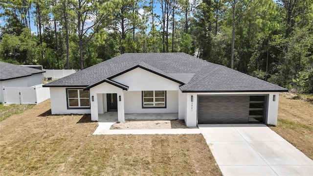 3461 W Webster Pl, Citrus Springs, FL 34433 - ranch-style home featuring a garage, roof with shingles, stucco siding, driveway, and view of wooded area
