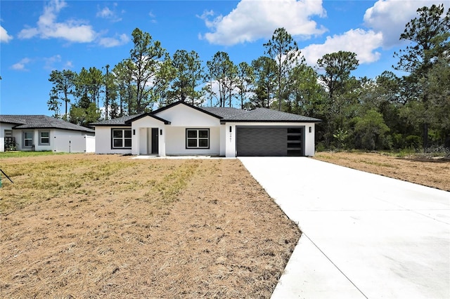 3461 W Webster Pl, Citrus Springs, FL 34433 - view of front of house with an attached garage, concrete driveway, stucco siding, and a front yard