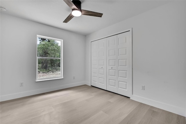 3461 W Webster Pl, Citrus Springs, FL 34433 - unfurnished bedroom with light wood-style floors, baseboards, a closet, and ceiling fan