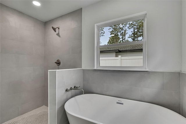 3461 W Webster Pl, Citrus Springs, FL 34433 - bathroom with a walk in shower, a soaking tub, tile walls, and recessed lighting