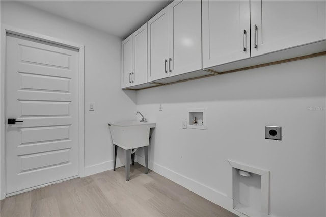 3461 W Webster Pl, Citrus Springs, FL 34433 - washroom featuring cabinet space, electric dryer hookup, hookup for a washing machine, light wood-type flooring, and baseboards