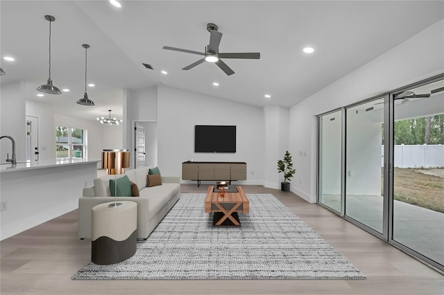 3461 W Webster Pl, Citrus Springs, FL 34433 - living room featuring vaulted ceiling, light wood-style floors, a ceiling fan, baseboards, and recessed lighting