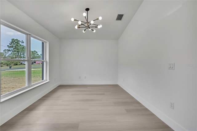 3461 W Webster Pl, Citrus Springs, FL 34433 - unfurnished room featuring a chandelier, light wood-type flooring, and baseboards