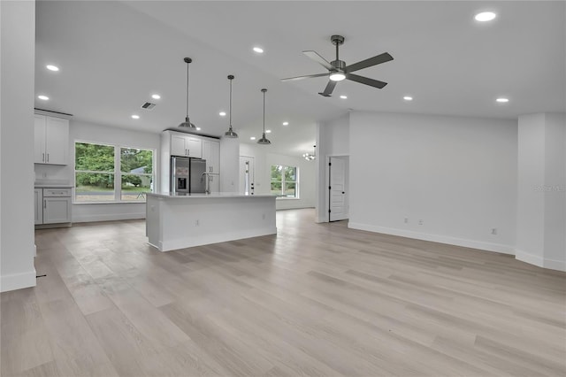 3461 W Webster Pl, Citrus Springs, FL 34433 - unfurnished living room with healthy amount of natural light, a ceiling fan, baseboards, light wood-type flooring, and recessed lighting