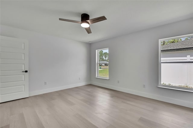 3461 W Webster Pl, Citrus Springs, FL 34433 - empty room with healthy amount of natural light, a ceiling fan, light wood-type flooring, and baseboards