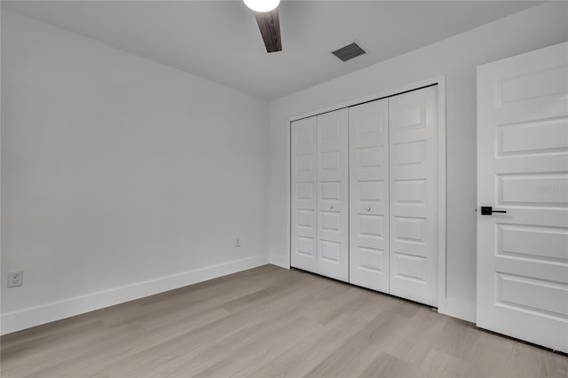 3461 W Webster Pl, Citrus Springs, FL 34433 - unfurnished bedroom featuring light wood-style flooring, baseboards, a closet, and a ceiling fan