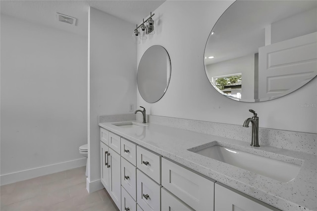 3461 W Webster Pl, Citrus Springs, FL 34433 - bathroom with double vanity, toilet, tile patterned flooring, and baseboards