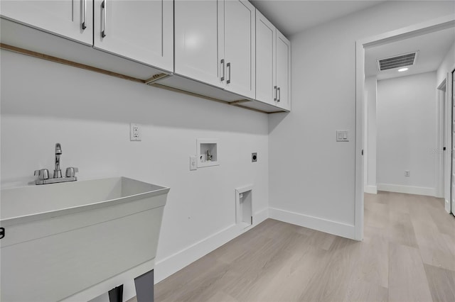 3461 W Webster Pl, Citrus Springs, FL 34433 - washroom with cabinet space, electric dryer hookup, light wood-style floors, washer hookup, and baseboards
