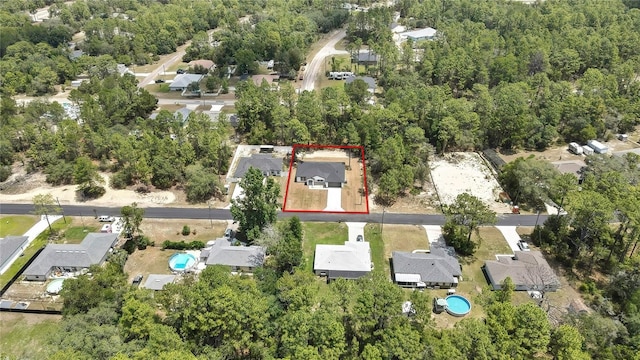 3461 W Webster Pl, Citrus Springs, FL 34433 - aerial view of property and surrounding area featuring property parcel outlined, nearby suburban area, and a forest
