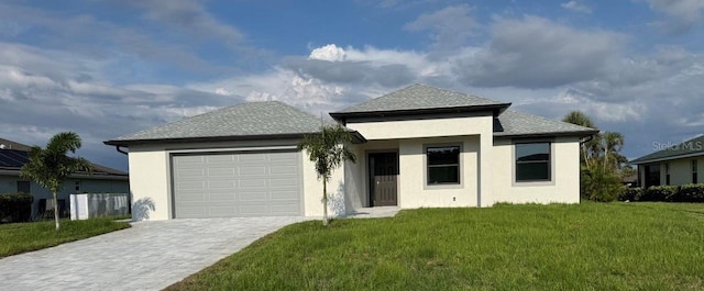 9 Bunker Pl, Rotonda West, FL 33947 - view of front of property with a garage, decorative driveway, a front yard, and stucco siding