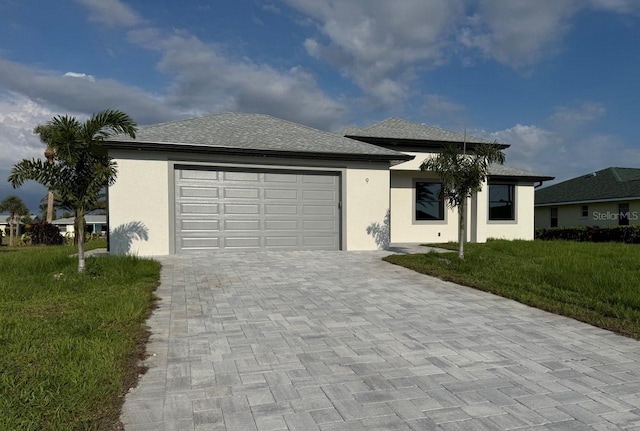 9 Bunker Pl, Rotonda West, FL 33947 - view of front of home featuring decorative driveway, an attached garage, stucco siding, and a front yard